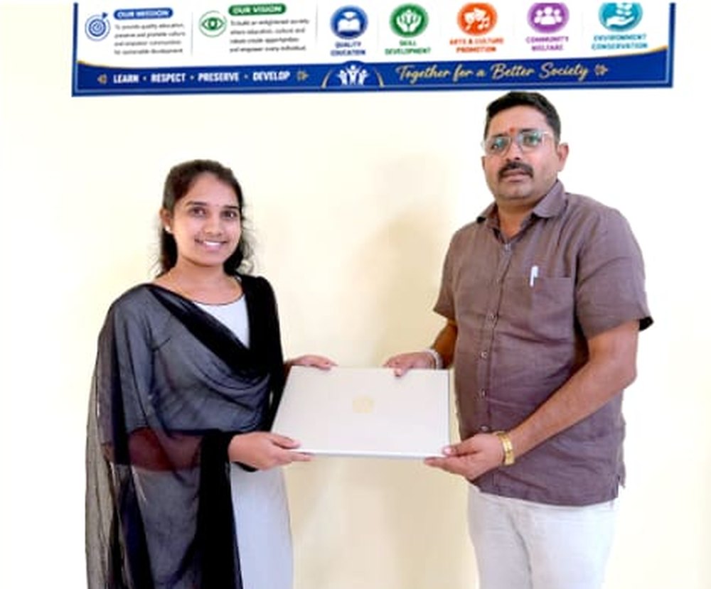 A director presenting a laptop to a student