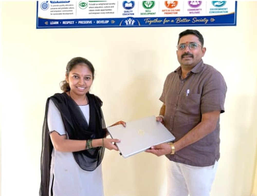 A director presenting a laptop to a student